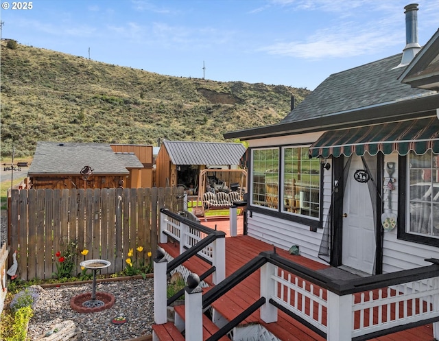 wooden deck with fence and a mountain view