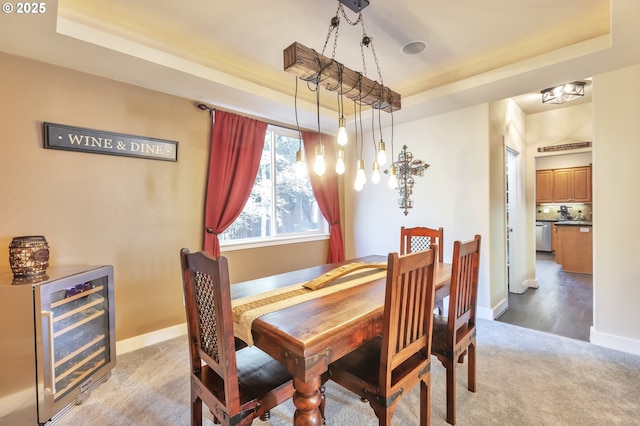 12130 SW Kelly Ln, Tigard, OR 97223 - carpeted dining space with a raised ceiling, wine cooler, and baseboards