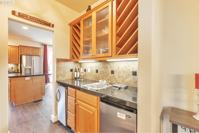 12130 SW Kelly Ln, Tigard, OR 97223 - kitchen featuring a sink, appliances with stainless steel finishes, glass insert cabinets, dark wood-type flooring, and backsplash