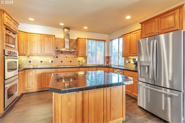 12130 SW Kelly Ln, Tigard, OR 97223 - kitchen with stainless steel appliances, wall chimney exhaust hood, a sink, wood finished floors, and decorative backsplash
