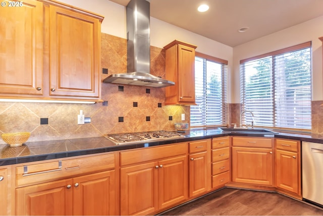 12130 SW Kelly Ln, Tigard, OR 97223 - kitchen featuring wall chimney exhaust hood, a sink, appliances with stainless steel finishes, wood finished floors, and tasteful backsplash