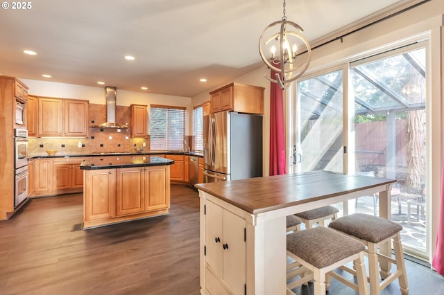 12130 SW Kelly Ln, Tigard, OR 97223 - kitchen featuring wall chimney range hood, appliances with stainless steel finishes, plenty of natural light, a chandelier, and recessed lighting