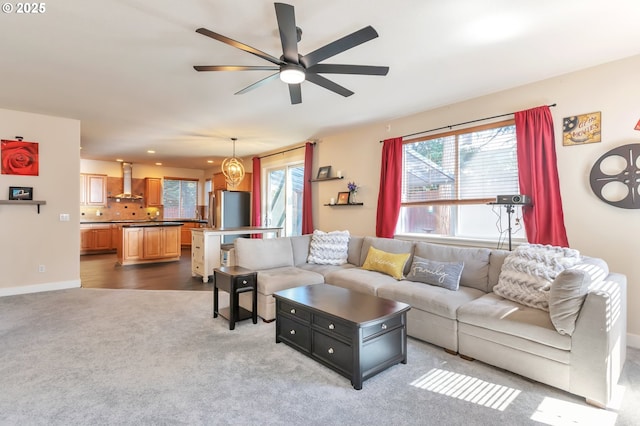 12130 SW Kelly Ln, Tigard, OR 97223 - carpeted living room with healthy amount of natural light, a ceiling fan, and baseboards