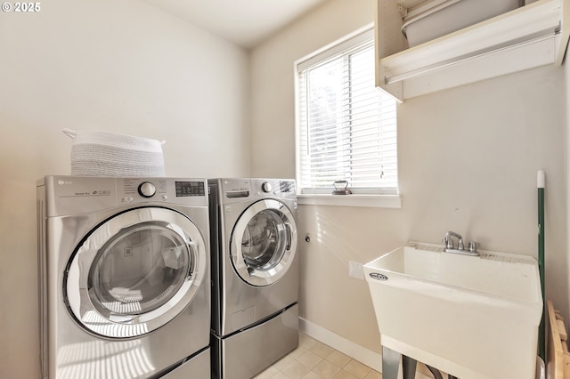 12130 SW Kelly Ln, Tigard, OR 97223 - laundry area with washer and clothes dryer, light tile patterned floors, and baseboards
