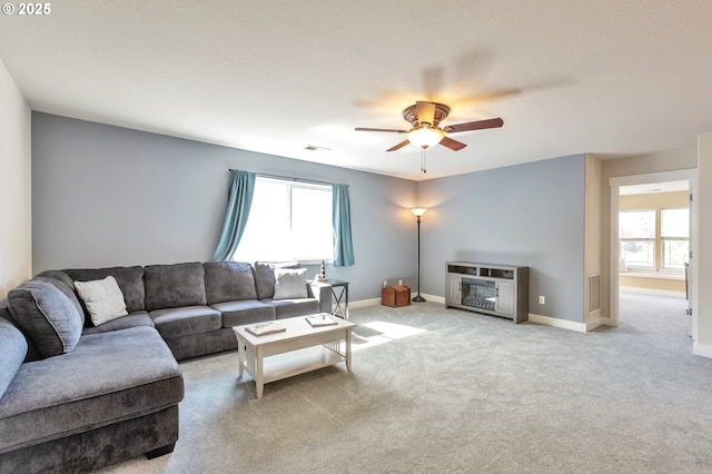 12130 SW Kelly Ln, Tigard, OR 97223 - carpeted living area featuring healthy amount of natural light, a ceiling fan, and baseboards