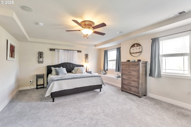 12130 SW Kelly Ln, Tigard, OR 97223 - bedroom featuring a tray ceiling, light colored carpet, baseboards, and ceiling fan