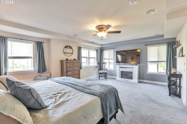 12130 SW Kelly Ln, Tigard, OR 97223 - carpeted bedroom with multiple windows, baseboards, and a fireplace with raised hearth