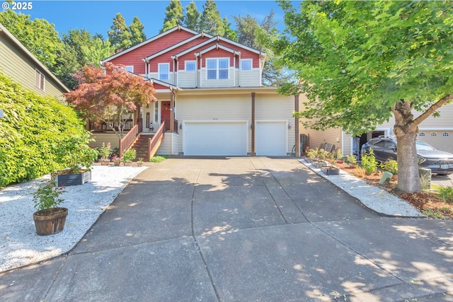 12130 SW Kelly Ln, Tigard, OR 97223 - view of front of home featuring a garage, concrete driveway, and stairway