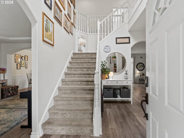17717 NE 26th St, Vancouver, WA 98684 - stairs featuring arched walkways, wood finished floors, and a high ceiling
