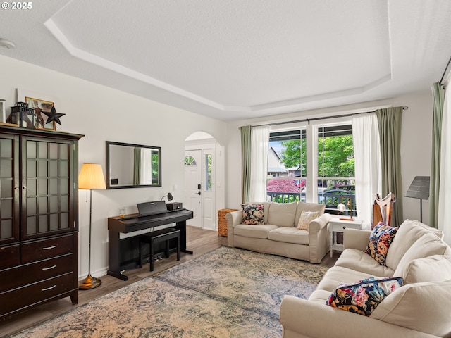 17717 NE 26th St, Vancouver, WA 98684 - living room with a tray ceiling, wood finished floors, and arched walkways