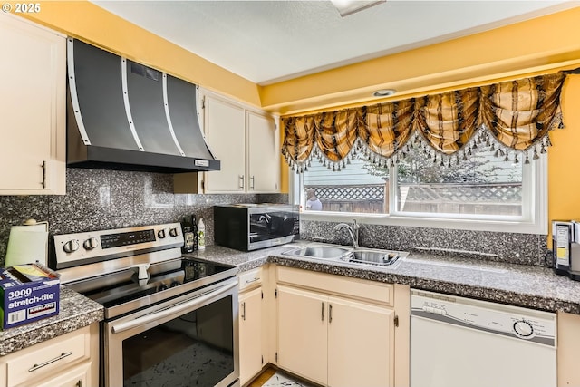 17180 NW Joscelyn St, Beaverton, OR 97006 - kitchen with wall chimney exhaust hood, stainless steel appliances, a sink, dark countertops, and tasteful backsplash