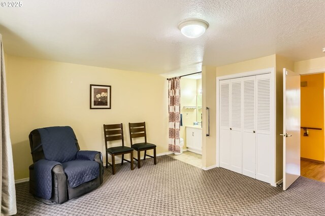 17180 NW Joscelyn St, Beaverton, OR 97006 - living area featuring carpet, baseboards, and a textured ceiling