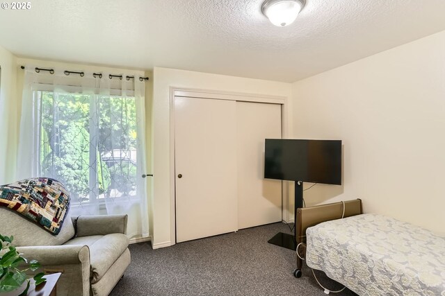 17180 NW Joscelyn St, Beaverton, OR 97006 - carpeted bedroom featuring a textured ceiling, multiple windows, and a closet