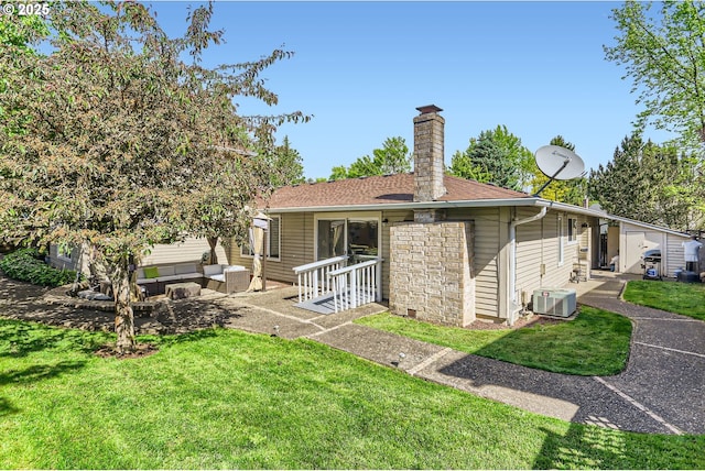 17180 NW Joscelyn St, Beaverton, OR 97006 - rear view of house with outdoor lounge area, a chimney, central air condition unit, a yard, and stone siding