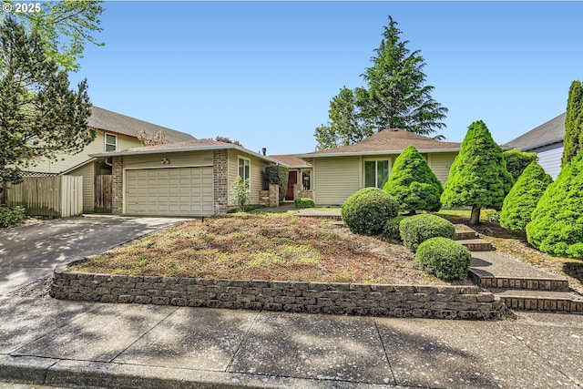 17180 NW Joscelyn St, Beaverton, OR 97006 - view of front of property with a garage, concrete driveway, brick siding, and fence