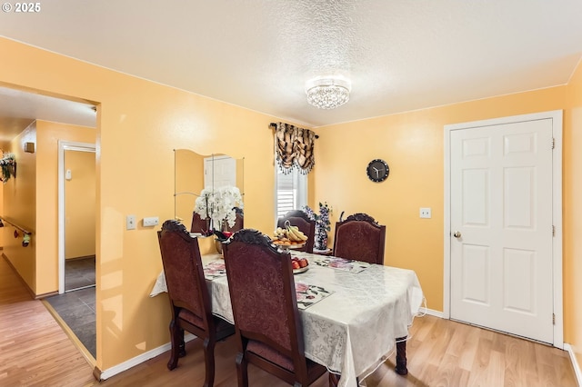 17180 NW Joscelyn St, Beaverton, OR 97006 - dining space with wood finished floors, baseboards, and a textured ceiling