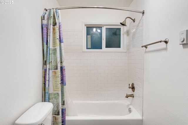 bathroom featuring shower / bathtub combination with curtain and toilet