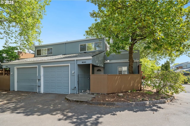1630 NW Eastbrook Ct, Beaverton, OR 97006 - view of front of home with roof with shingles, asphalt driveway, and a garage