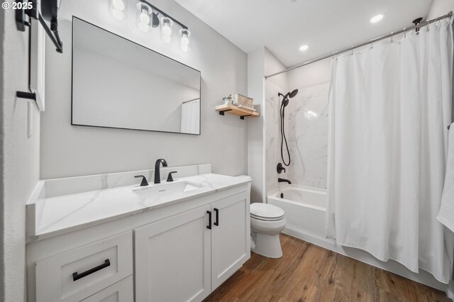 bathroom featuring toilet, wood finished floors, recessed lighting, shower / tub combo, and vanity