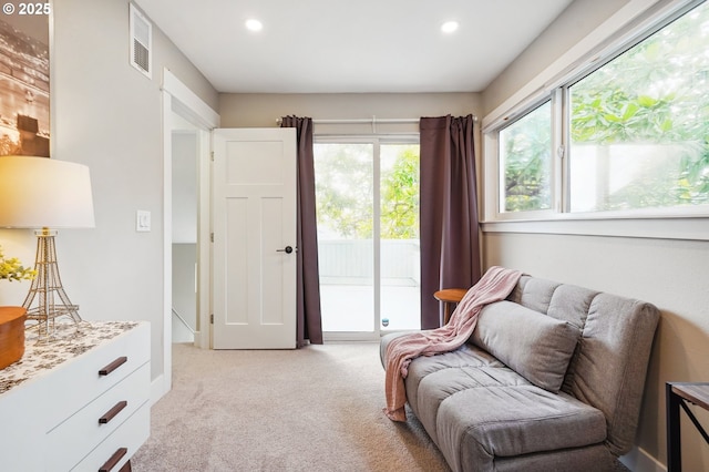 sitting room featuring recessed lighting, light colored carpet, and visible vents