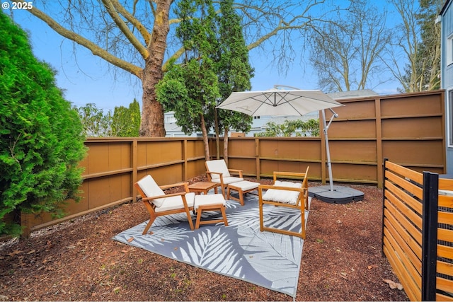 view of patio featuring an outdoor living space and a fenced backyard