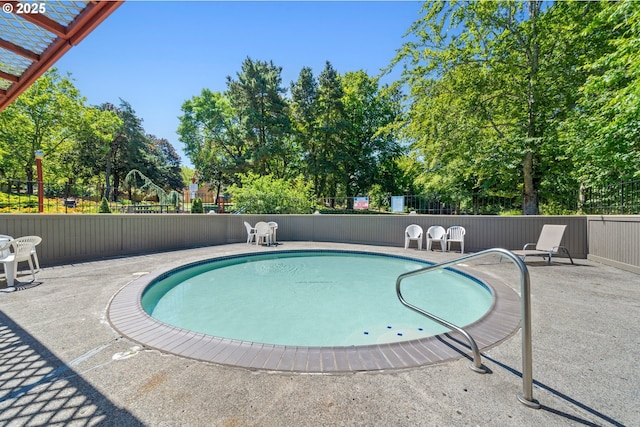 view of swimming pool with a fenced in pool, a patio, and fence