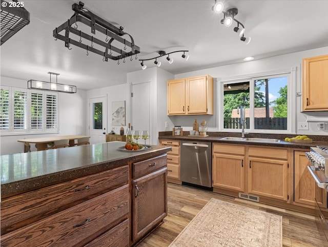 14108 NE 94th St, Vancouver, WA 98682 - kitchen with stainless steel dishwasher, light wood-style floors, and light brown cabinetry