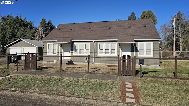 view of front of property featuring a garage and a front lawn