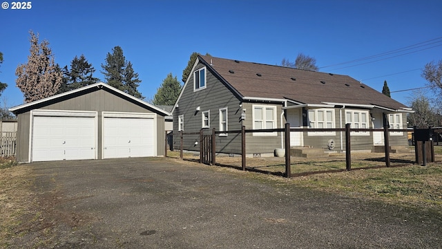 view of front of property featuring an outbuilding and a garage