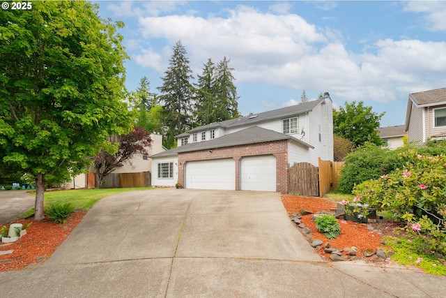 17474 SW Sarala St, Beaverton, OR 97007 - traditional home with fence, concrete driveway, brick siding, a garage, and a gate