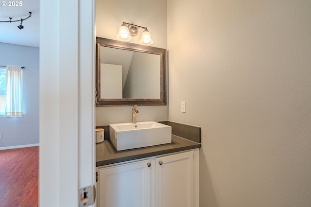17474 SW Sarala St, Beaverton, OR 97007 - bathroom featuring wood finished floors, vanity, and baseboards