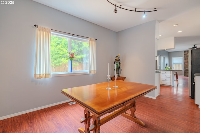 17474 SW Sarala St, Beaverton, OR 97007 - dining room featuring baseboards, wood finished floors, track lighting, and recessed lighting