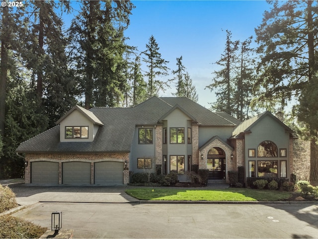 view of front of home with brick siding, concrete driveway, a garage, and roof with shingles