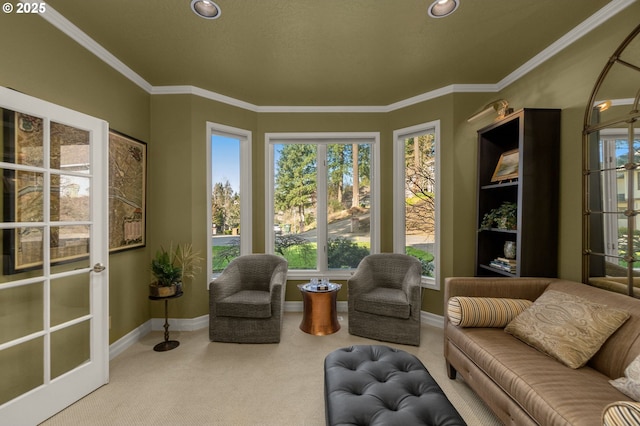 living area featuring crown molding, carpet flooring, and baseboards