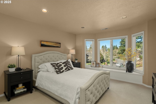 bedroom featuring recessed lighting, light colored carpet, visible vents, and baseboards