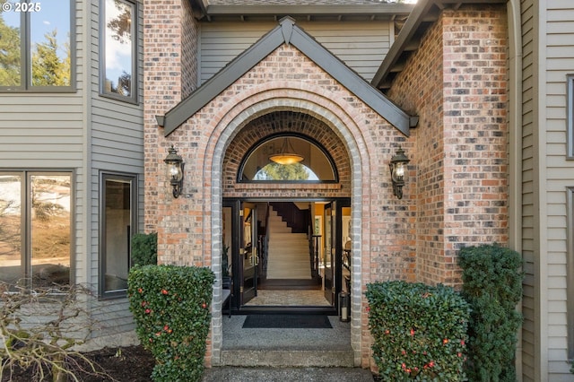 doorway to property with brick siding