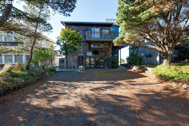 back of property featuring a balcony