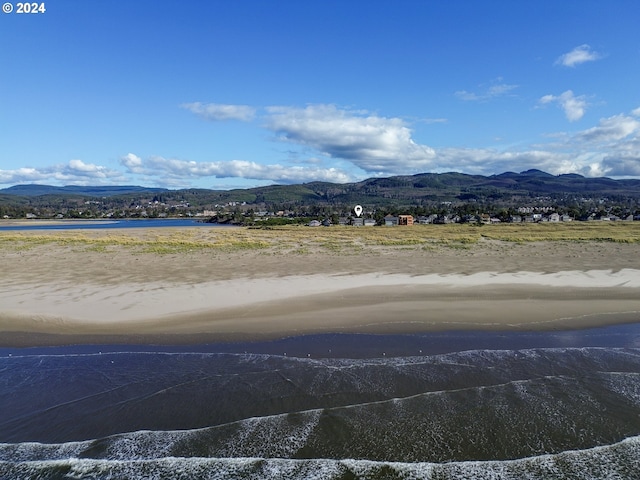 exterior space with a water and mountain view