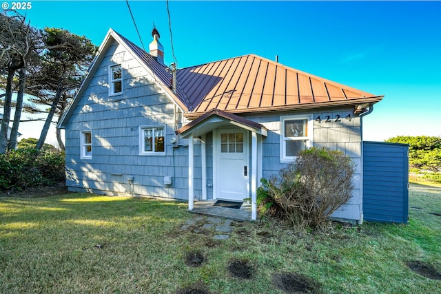 rear view of property featuring a lawn