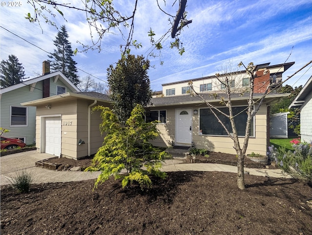 1917 SE 51st Ave, Portland, OR 97215 - traditional-style house featuring a garage, a chimney, and driveway