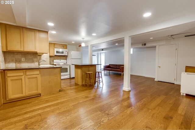 1917 SE 51st Ave, Portland, OR 97215 - kitchen with decorative backsplash, white appliances, open floor plan, light wood-type flooring, and a sink