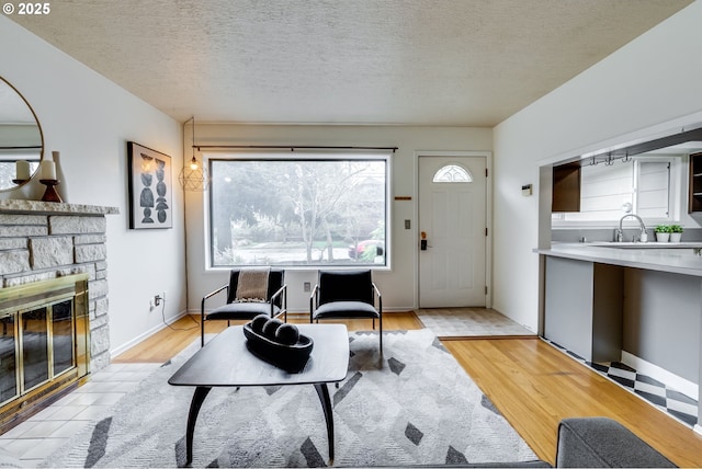 1917 SE 51st Ave, Portland, OR 97215 - living area with a fireplace, light wood-style flooring, and a textured ceiling