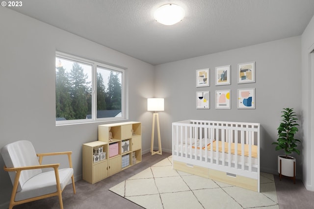 bedroom with a textured ceiling, light colored carpet, and a crib