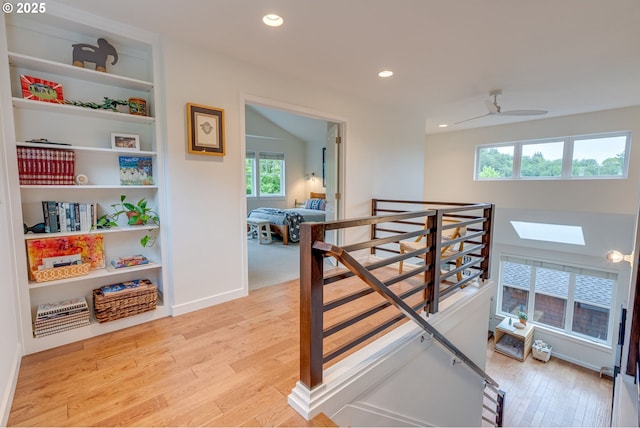 staircase with wood finished floors, healthy amount of natural light, recessed lighting, and baseboards