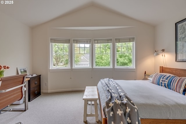 bedroom featuring vaulted ceiling, multiple windows, carpet, and baseboards