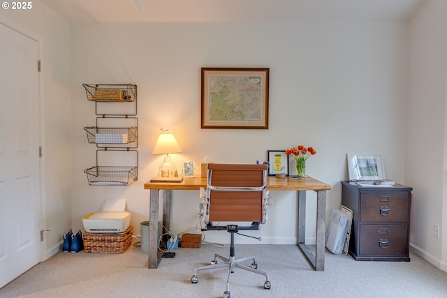 carpeted home office featuring baseboards