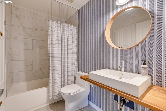 bathroom with toilet, wallpapered walls, shower / tub combo with curtain, and a sink