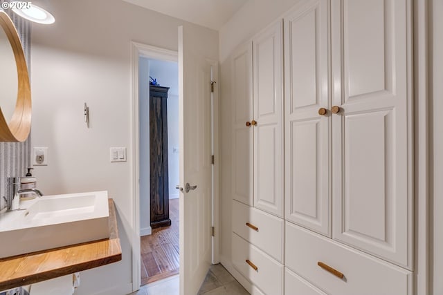 bathroom with a sink and baseboards
