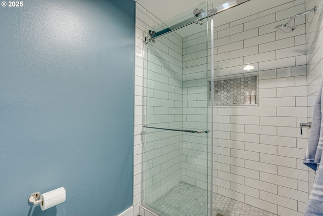 bathroom with a stall shower and a textured wall