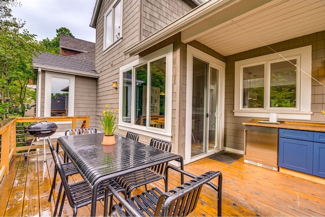 wooden deck featuring outdoor dining space